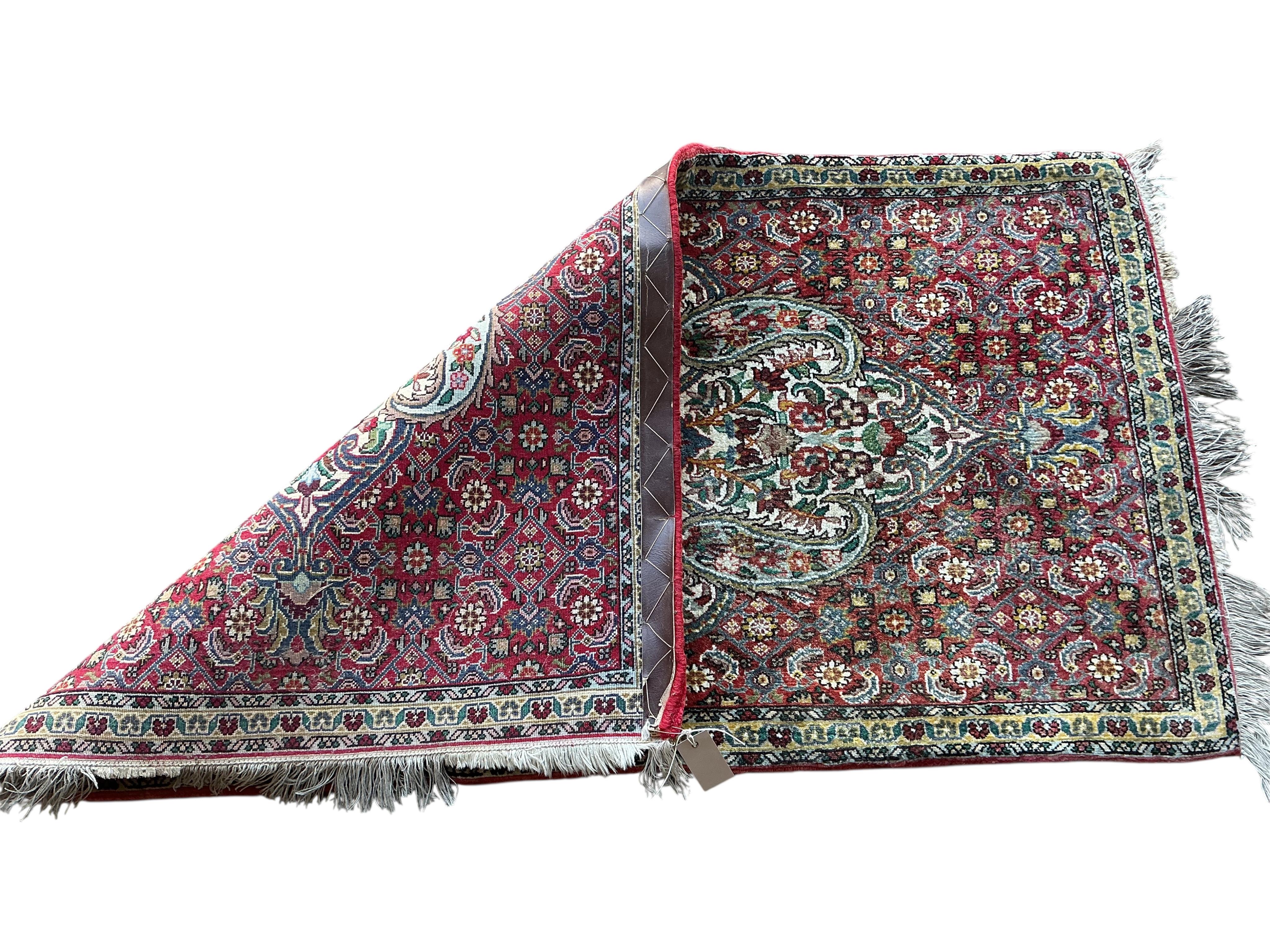 A North West Persian red ground medallion rug, 134 x 78cm
